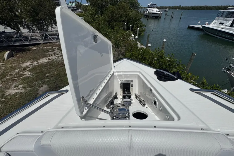 Slide: The Image of Open hatch on 2024 Formula 380 Super Sport Crossover OB boat, docked by the water. - 27