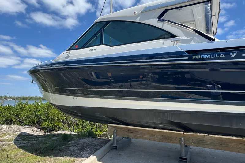 Slide: The Image of 2024 Formula 380 Super Sport Crossover OB boat on display, side view with blue sky background. - 3