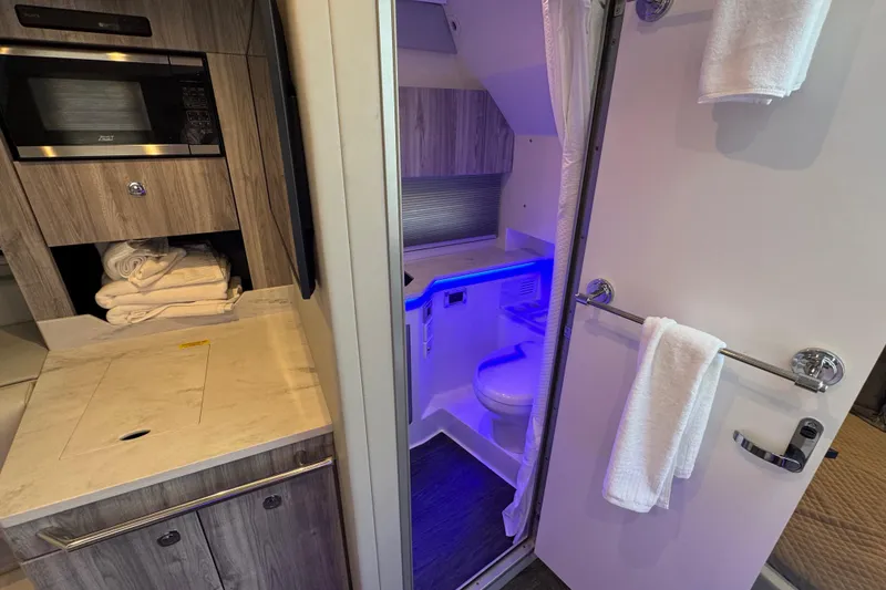 Slide: The Image of 2024 Formula 380 Super Sport Crossover OB interior with modern bathroom and kitchenette. - 32