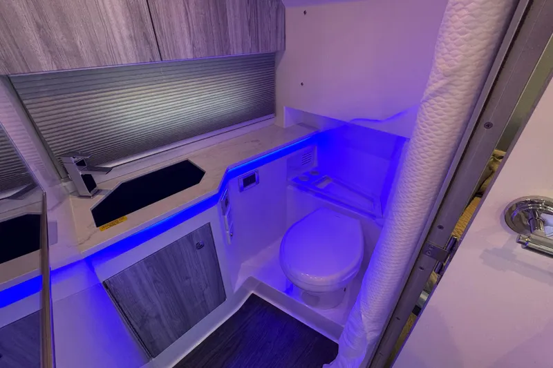 Slide: The Image of 2024 Formula 380 Super Sport Crossover OB bathroom with modern design and blue LED lighting. - 33