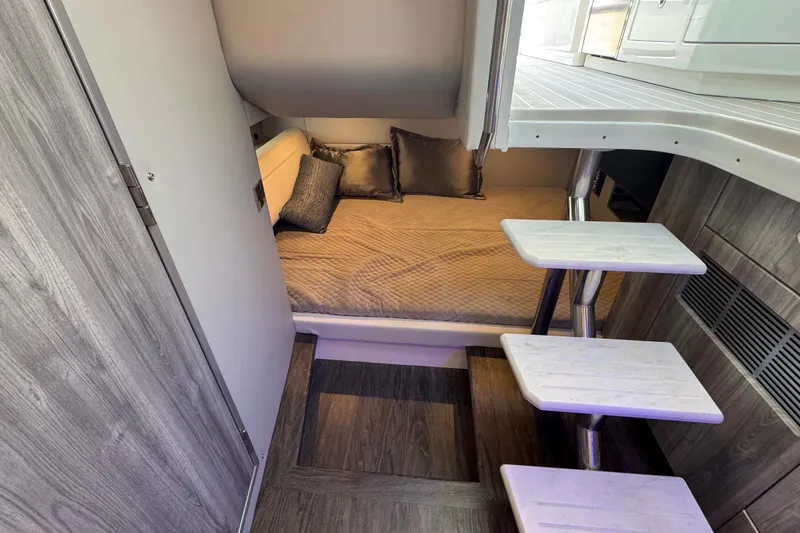 Slide: The Image of 2024 Formula 380 Super Sport Crossover OB cabin with cozy bed and modern interior design. - 34