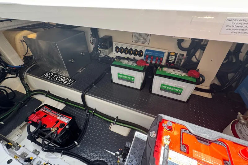 Slide: The Image of 2024 Formula 380 Super Sport Crossover OB engine compartment with batteries and wiring. - 38