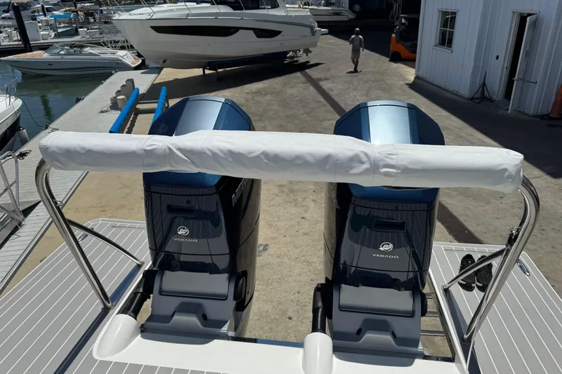 Slide: The Image of 2024 Formula 380 Super Sport Crossover OB with dual Verado engines at a marina. - 9