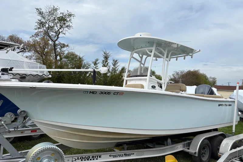 The Image of 2018 Sportsman Heritage 231 Center Console boat on trailer, outdoors. - 0