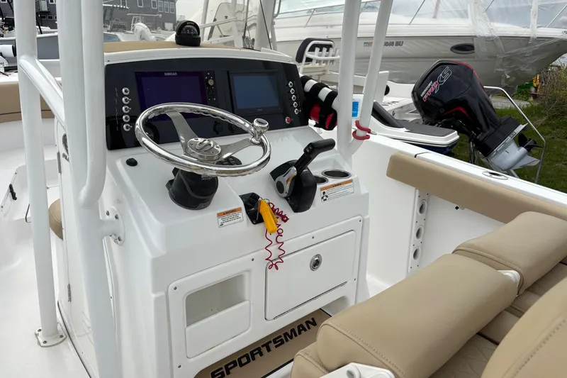 Slide: The Image of 2018 Sportsman Heritage 231 Center Console boat interior with steering wheel and controls. - 5