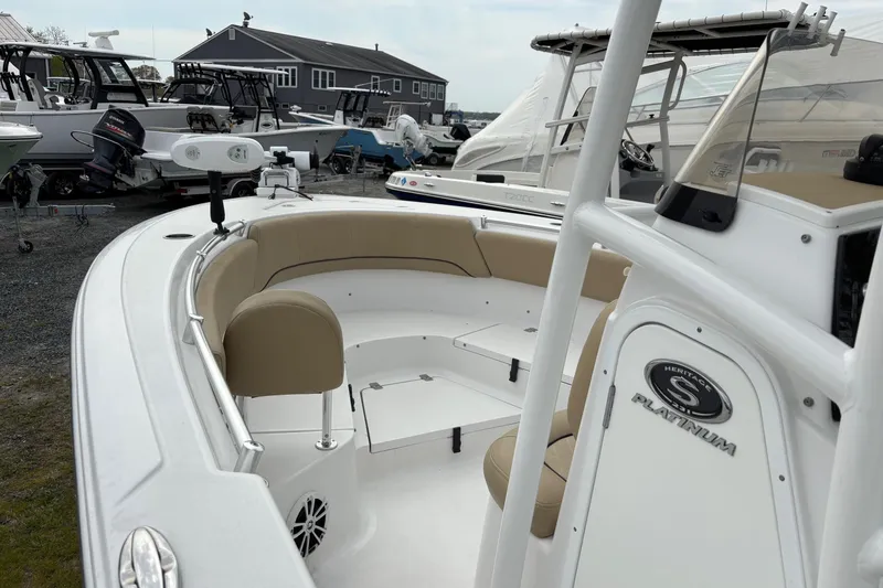 Slide: The Image of 2018 Sportsman Heritage 231 Center Console boat with beige seating, docked outdoors. - 6