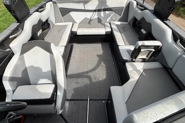Slide: The Image of 2019 Supreme ZS232 boat interior with gray seating and carpeted floor. - 11