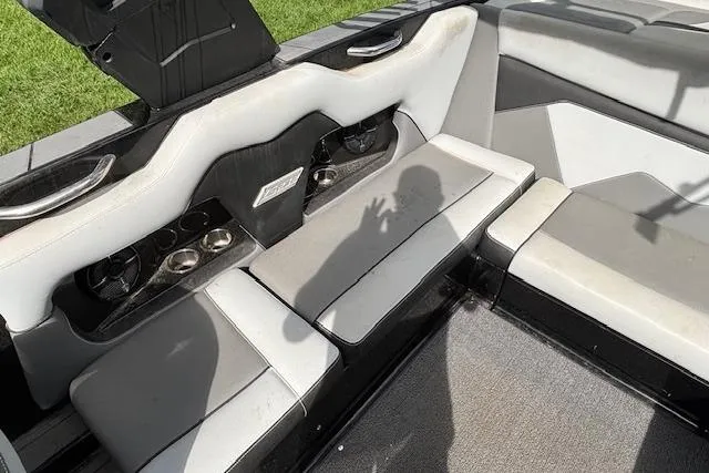 Slide: The Image of 2019 Supreme ZS232 boat interior with gray seating and cup holders. - 12