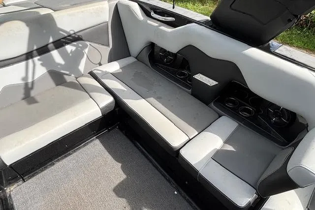Slide: The Image of Interior seating of 2019 Supreme ZS232 boat with cup holders and gray upholstery. - 13