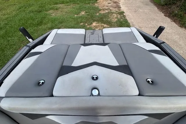 Slide: The Image of 2019 Supreme ZS232 boat with gray cushioned seating, parked on grass near a pathway. - 17