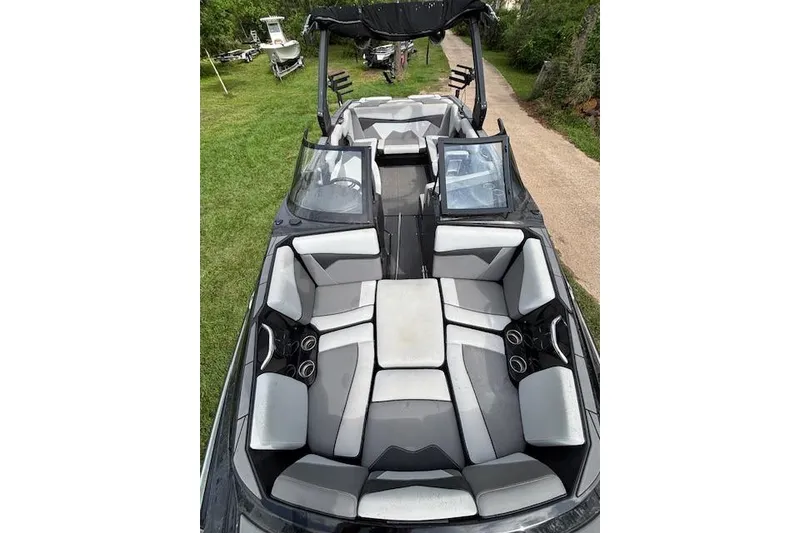 Slide: The Image of 2019 Supreme ZS232 boat interior with gray seating and cup holders. - 19
