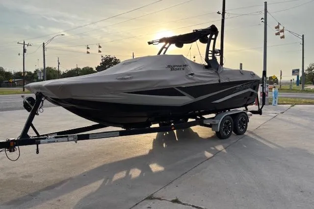 Slide: The Image of 2019 Supreme ZS232 boat on trailer at sunset, covered and parked outdoors. - 5