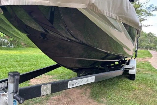 Slide: The Image of 2019 Supreme ZS232 boat on trailer, parked on grass. - 7