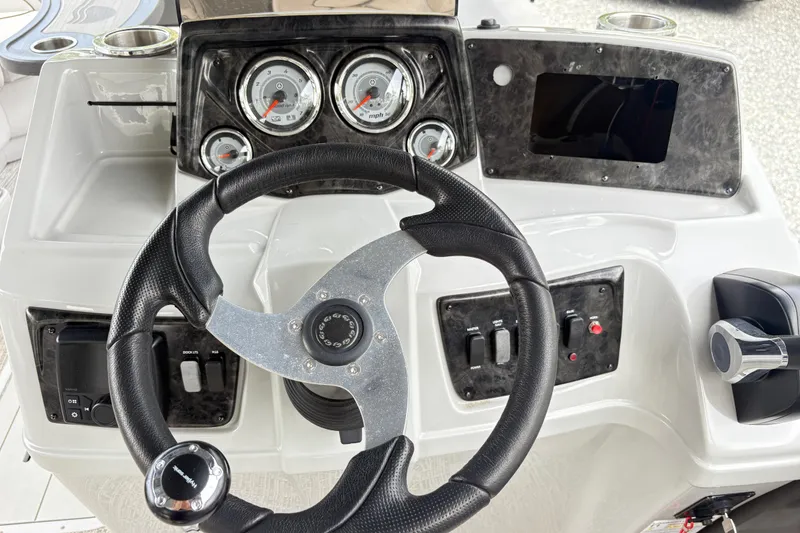 Slide: The Image of 2023 SunCatcher X322 RC boat dashboard with steering wheel and control panel. - 13