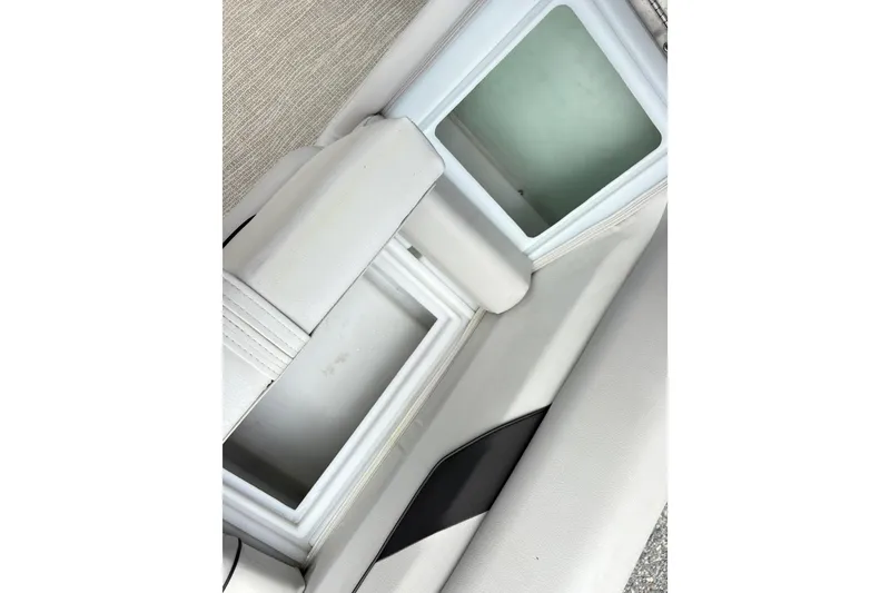 Slide: The Image of Interior storage compartments of 2023 SunCatcher X322 RC boat, featuring sleek white upholstery. - 15