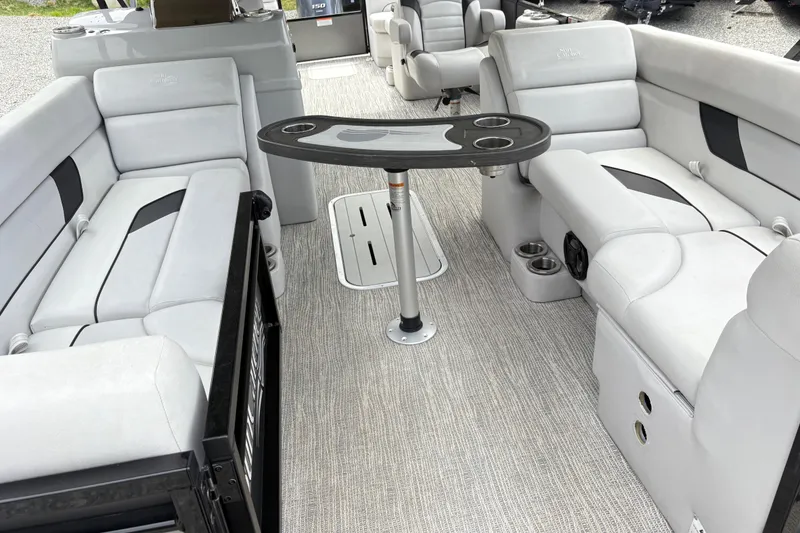 Slide: The Image of 2023 SunCatcher X322 RC boat interior with plush seating and central table. - 17