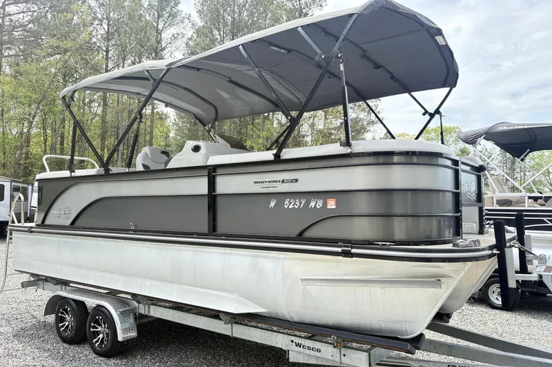 Slide: The Image of 2023 SunCatcher X322 RC pontoon boat on trailer, parked outdoors. - 3