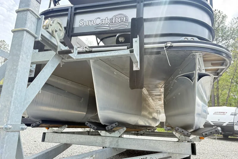 Slide: The Image of 2023 SunCatcher X322 RC pontoon boat on trailer, showcasing aluminum pontoons and sturdy frame. - 5