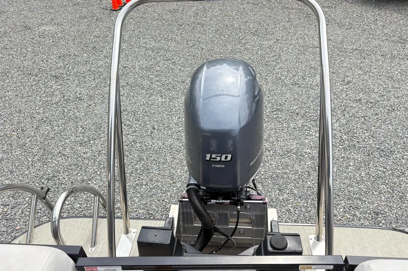Slide: The Image of 2023 SunCatcher X322 RC boat with Yamaha 150 engine, displayed on gravel surface. - 6