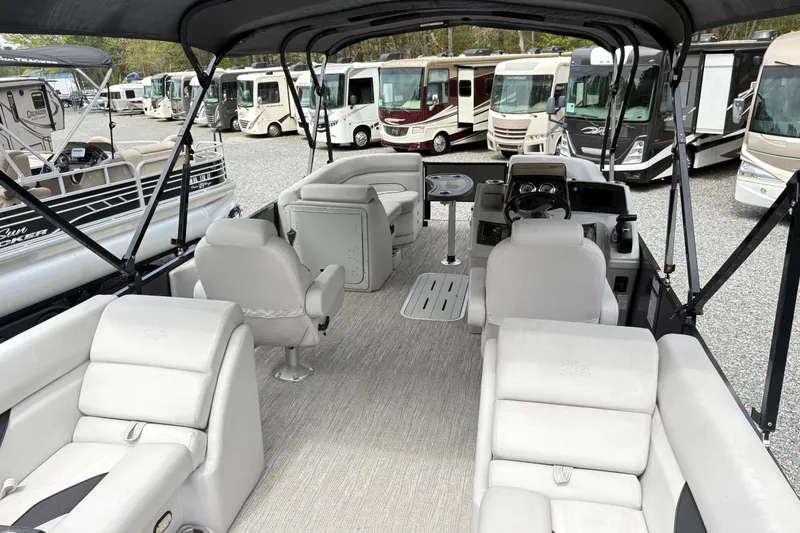 Slide: The Image of 2023 SunCatcher X322 RC pontoon boat interior with plush seating and modern dashboard. - 7