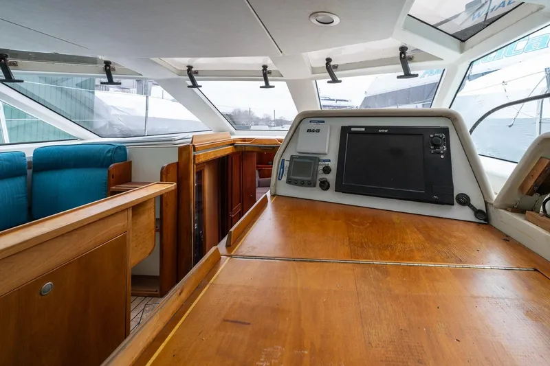 Slide: The Image of Interior view of 2001 Kanter Bougainvillea 62 yacht with navigation equipment and wooden furnishings. - 10