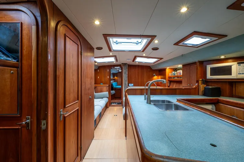 Slide: The Image of Luxurious 2001 Kanter Bougainvillea 62 yacht interior with wood finishes and modern kitchen amenities. - 13