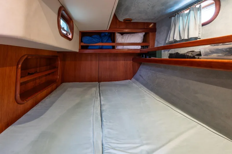 Slide: The Image of Cozy cabin interior of 2001 Kanter Bougainvillea 62 yacht with wooden accents and bedding. - 15