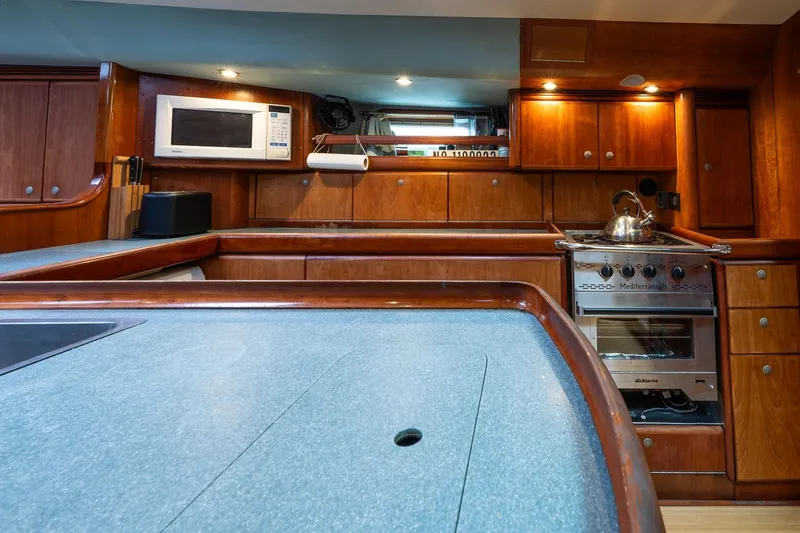 Slide: The Image of Luxurious kitchen interior of 2001 Kanter Bougainvillea 62 yacht with wooden cabinetry. - 20