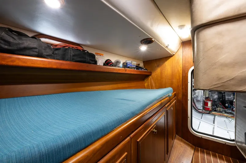 Slide: The Image of Cozy cabin interior of 2001 Kanter Bougainvillea 62 yacht with blue bedding. - 21
