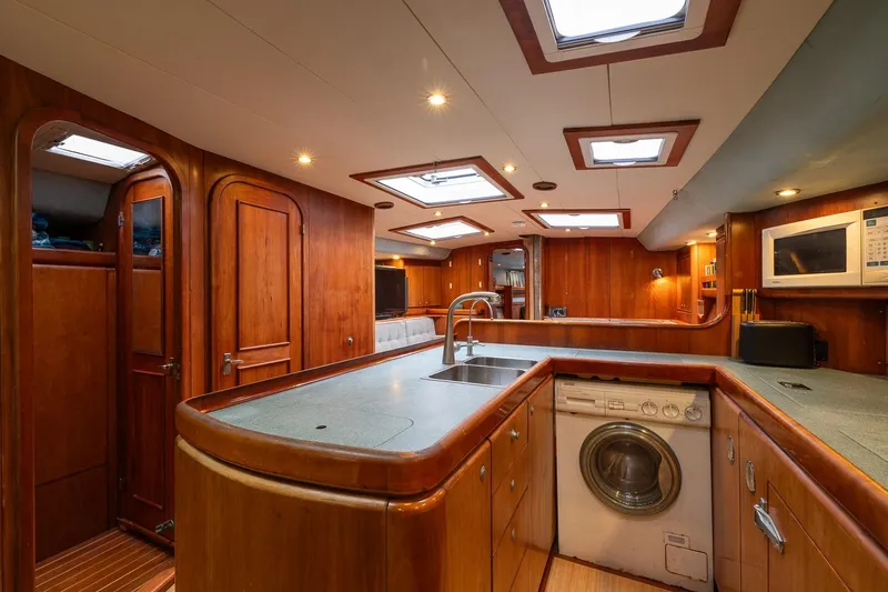 Slide: The Image of Luxurious 2001 Kanter Bougainvillea 62 yacht interior with modern kitchen and wooden cabinetry. - 24