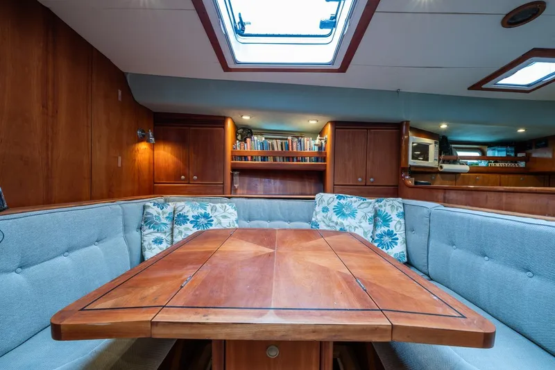 Slide: The Image of Interior of 2001 Kanter Bougainvillea 62 yacht with wooden table and cushioned seating. - 29