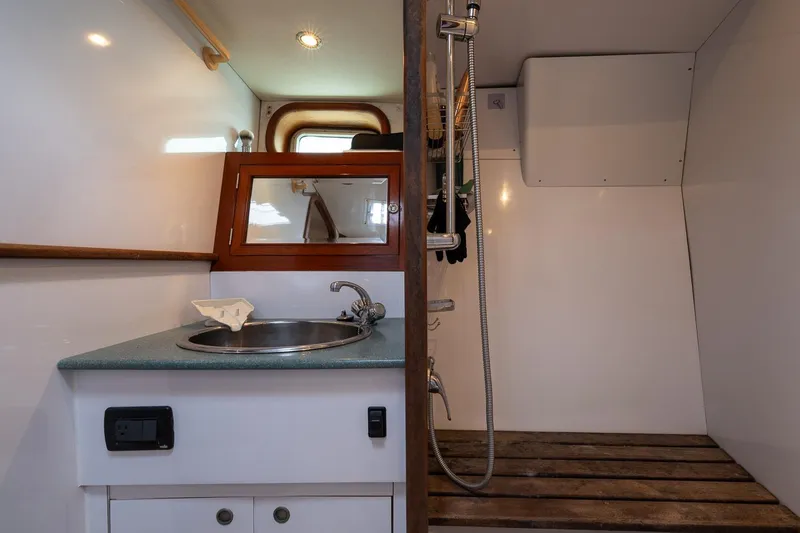 Slide: The Image of Compact bathroom in 2001 Kanter Bougainvillea 62 yacht with sink and shower area. - 34