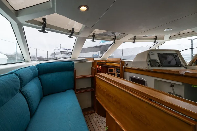 Slide: The Image of Interior of 2001 Kanter Bougainvillea 62 yacht with blue seating and navigation equipment. - 8