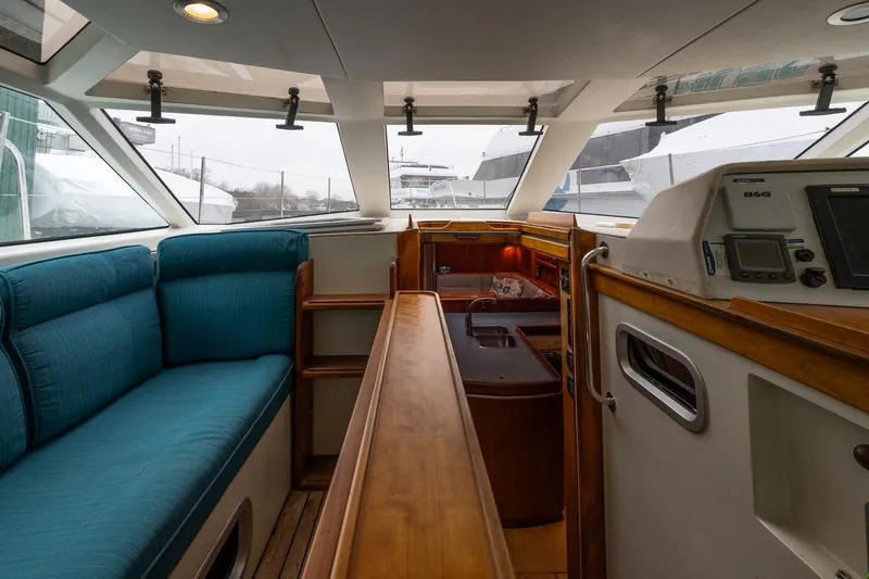 Slide: The Image of Interior of 2001 Kanter Bougainvillea 62 yacht with blue seating and navigation equipment. - 9