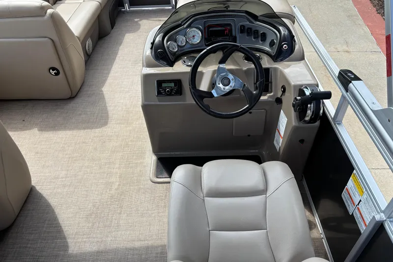Slide: The Image of 2022 Sun Tracker Party Barge 20 DLX helm with steering wheel and controls. - 5