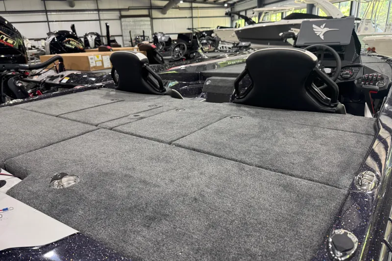 Slide: The Image of 2026 Skeeter ZXE21 boat interior with spacious carpeted deck and dual seats. - 11