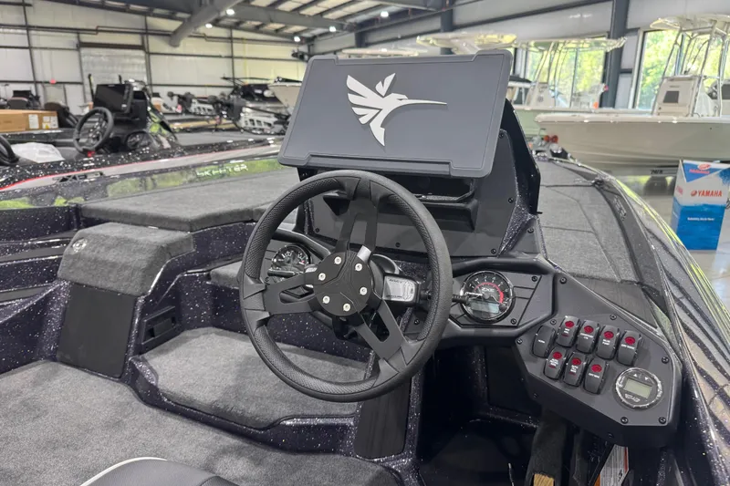 Slide: The Image of Interior view of 2026 Skeeter ZXE21 boat with steering wheel and control panel. - 12