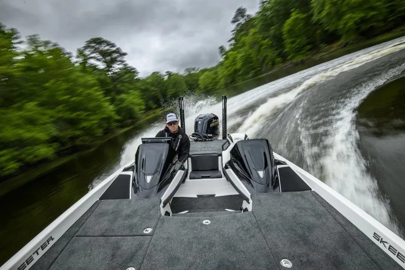 Slide: The Image of Manufacturer Provided Image: 2026 Skeeter ZXE21 boat speeding on a river with lush green surroundings. - 16