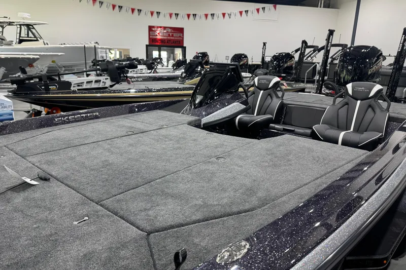 Slide: The Image of 2026 Skeeter ZXE21 boat interior with plush seating and spacious deck in showroom. - 6