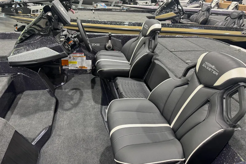 Slide: The Image of 2026 Skeeter ZXE21 boat interior with sleek black seating and modern dashboard. - 7