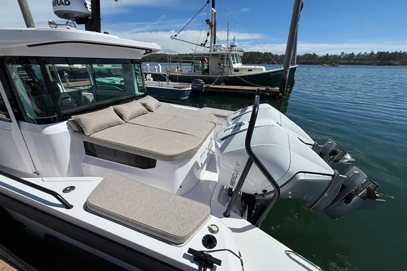 Slide: The Image of 2024 Axopar 37 XC Cross Cabin with Mercury engines docked at marina. - 17