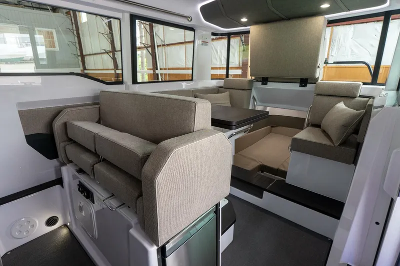 Slide: The Image of Interior of 2024 Axopar 37 Cross Cabin XC, featuring modern seating and ample natural light. - 18