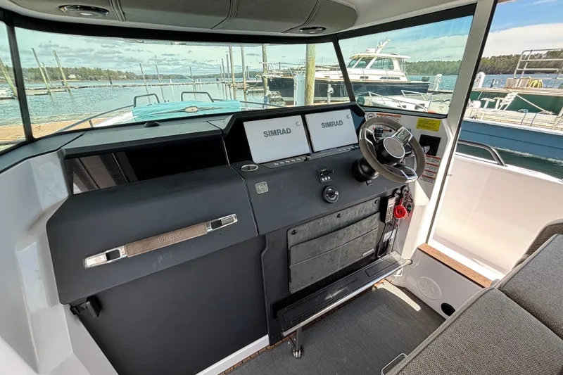 Slide: The Image of 2024 Axopar 37 XC Cross Cabin helm with Simrad displays, docked at marina. - 26