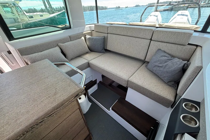 Slide: The Image of Luxurious seating area in 2024 Axopar 37 XC Cross Cabin boat with scenic water view. - 29