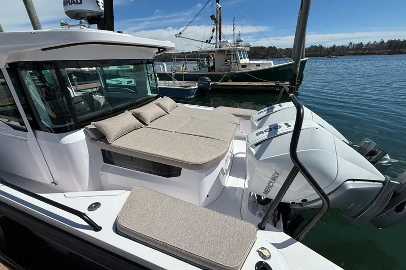 Slide: The Image of 2024 Axopar 37 XC Cross Cabin with Mercury engines docked by the water. - 3