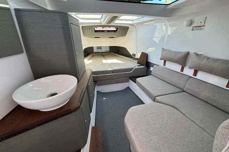 Slide: The Image of 2024 Axopar 37 XC Cross Cabin interior with modern seating and compact sink. - 30