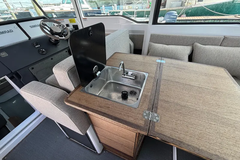 Slide: The Image of 2024 Axopar 37 XC Cross Cabin interior with sink and seating area. - 35