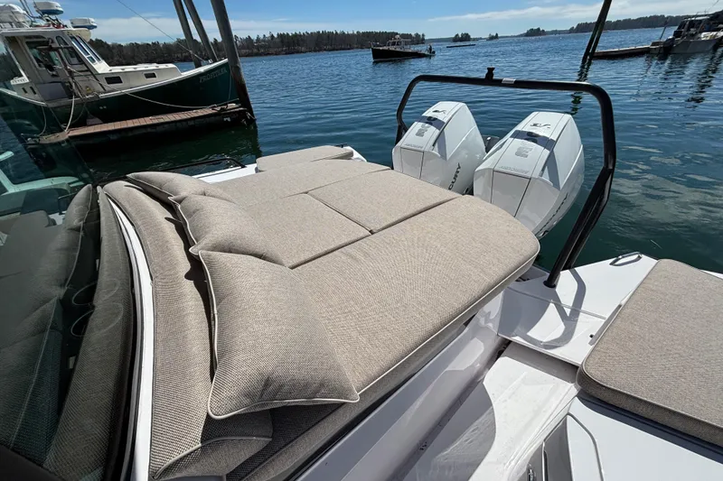 Slide: The Image of 2024 Axopar 37 XC Cross Cabin with twin outboard engines, docked on a sunny day. - 9