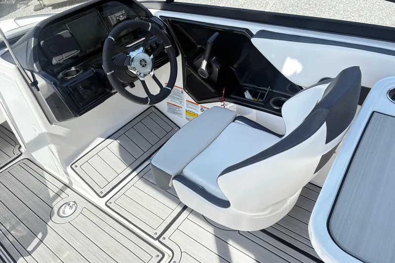 Slide: The Image of 2024 Yamaha Boats 195S cockpit with sleek steering wheel and modern seating design. - 7