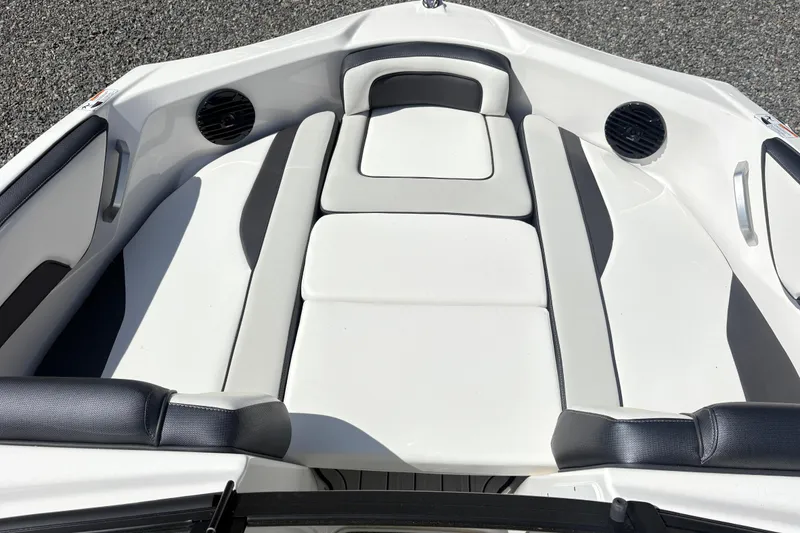 Slide: The Image of 2024 Yamaha Boats 195S interior seating with sleek white and black design. - 8